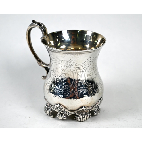 44 - A Victorian silver baluster half-pint mug with scroll handle, engraved decoration and scrolling feet... 