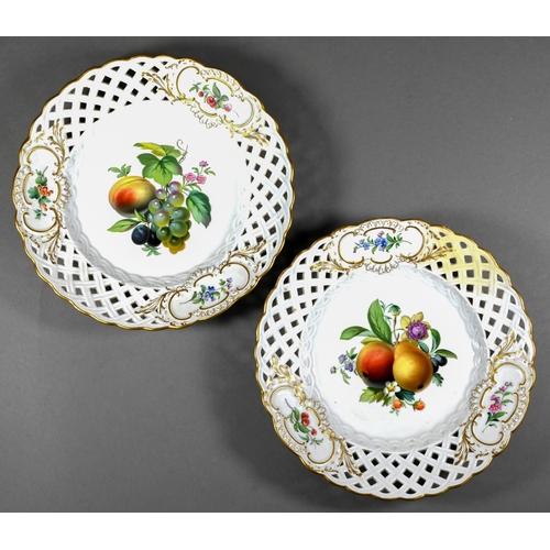 491 - A pair of Meissen wall-plates, finely painted with fruit and flowers, within pierced basketwork rims... 