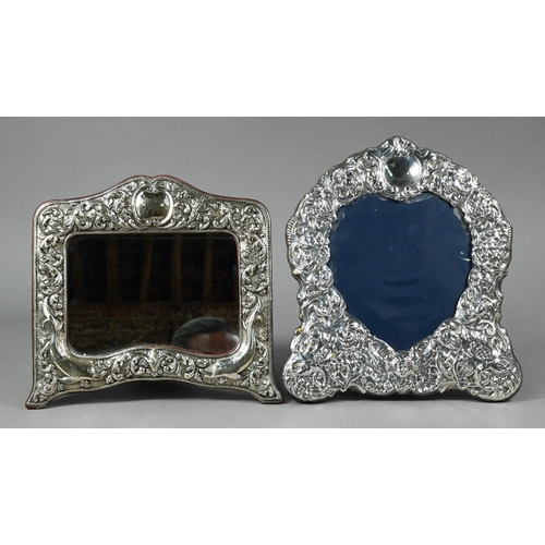 77 - An easel photograph frame with ornate embossed silver surround, Sheffield 1992, 28 x 25 cm to/w anot... 