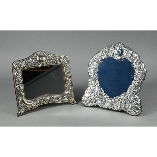 77 - An easel photograph frame with ornate embossed silver surround, Sheffield 1992, 28 x 25 cm to/w anot... 