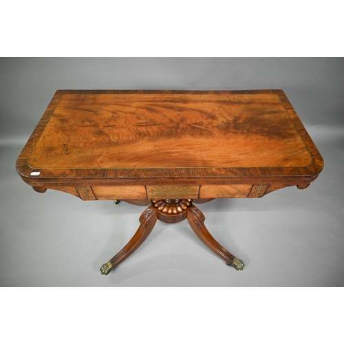 771 - A Regency brass inlaid rosewood card table, the fold over swivel top raised on a moulded support to ... 
