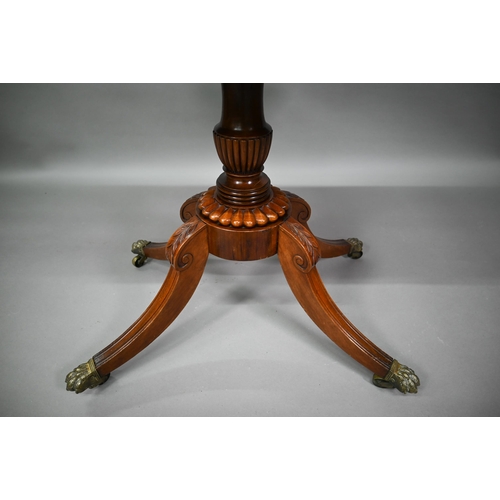 771 - A Regency brass inlaid rosewood card table, the fold over swivel top raised on a moulded support to ... 