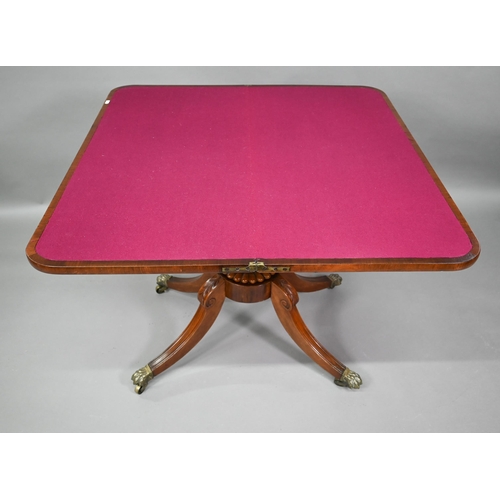 771 - A Regency brass inlaid rosewood card table, the fold over swivel top raised on a moulded support to ... 
