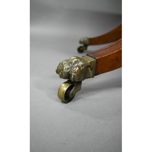 771 - A Regency brass inlaid rosewood card table, the fold over swivel top raised on a moulded support to ... 