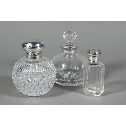 78 - Two globular cut glass cologne bottles with silver mounts, Sheffield/Birmingham 2000 to/w a smelling... 