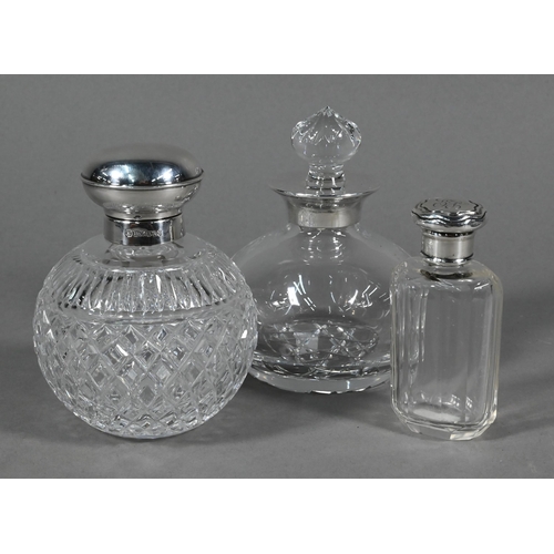 78 - Two globular cut glass cologne bottles with silver mounts, Sheffield/Birmingham 2000 to/w a smelling... 