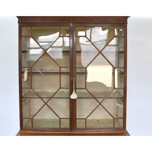 801 - A George III mahogany secretaire bookcase, the astragal glazed upper part two doors enclosing adjust... 