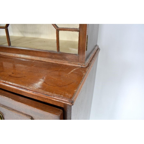 801 - A George III mahogany secretaire bookcase, the astragal glazed upper part two doors enclosing adjust... 