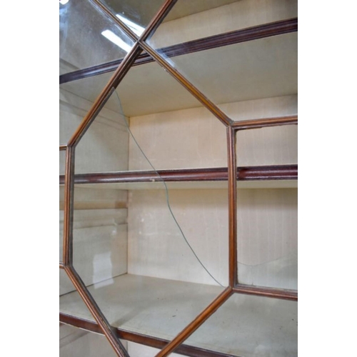 801 - A George III mahogany secretaire bookcase, the astragal glazed upper part two doors enclosing adjust... 