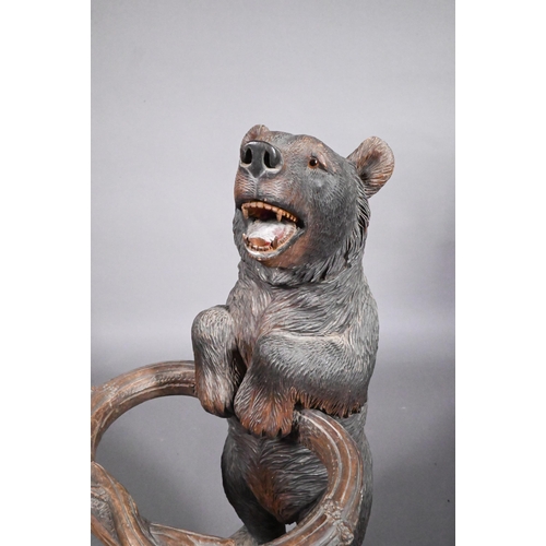 811 - A 19th century Black Forest carved bear stick stand, with glass eyes and open mouth, 86 cm h o/all