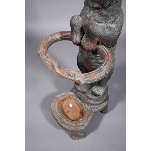 811 - A 19th century Black Forest carved bear stick stand, with glass eyes and open mouth, 86 cm h o/all