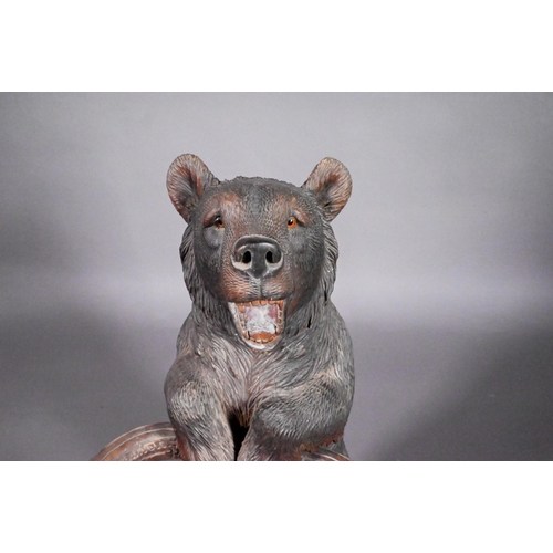 811 - A 19th century Black Forest carved bear stick stand, with glass eyes and open mouth, 86 cm h o/all