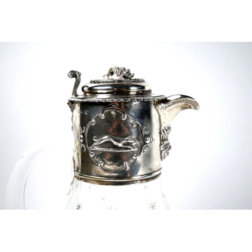 82 - A Victorian glass claret jug with star-cut decoration, the silver collar and cover surmounted and em... 