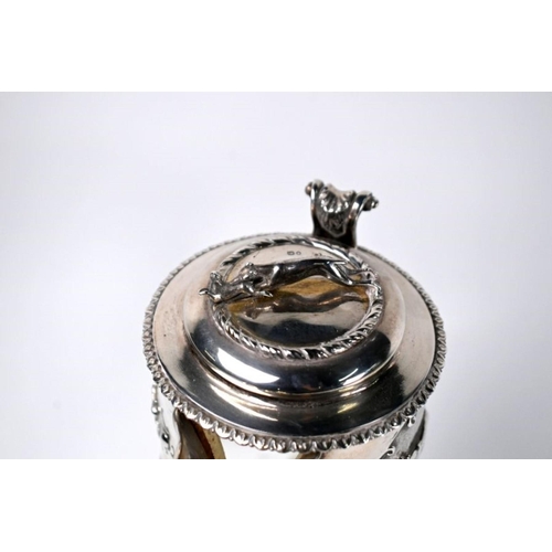 82 - A Victorian glass claret jug with star-cut decoration, the silver collar and cover surmounted and em... 