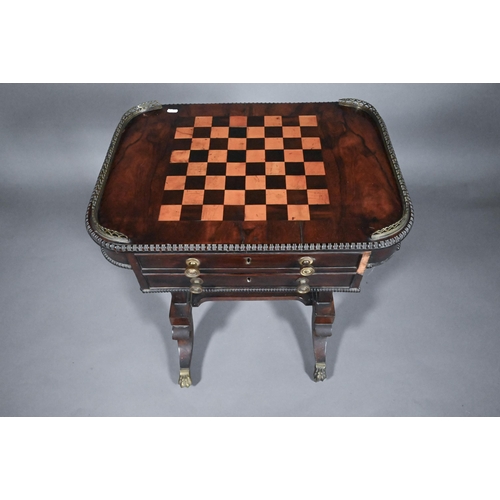 831 - A Regency rosewood games table, the chequerboard inset top flanked by pierced brass galleries to the... 