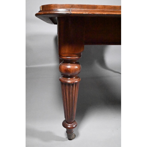 834 - A Victorian mahogany draw leaf extending dining table, raised on turned part gadrooned legs to brass... 