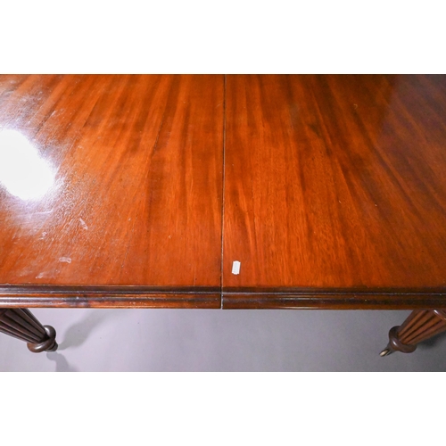 834 - A Victorian mahogany draw leaf extending dining table, raised on turned part gadrooned legs to brass... 