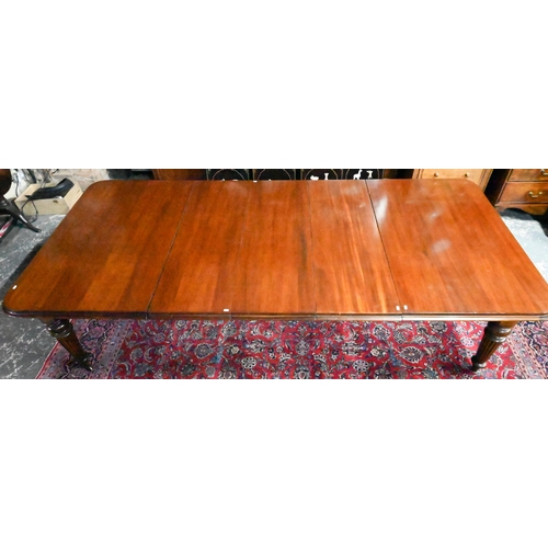 834 - A Victorian mahogany draw leaf extending dining table, raised on turned part gadrooned legs to brass... 