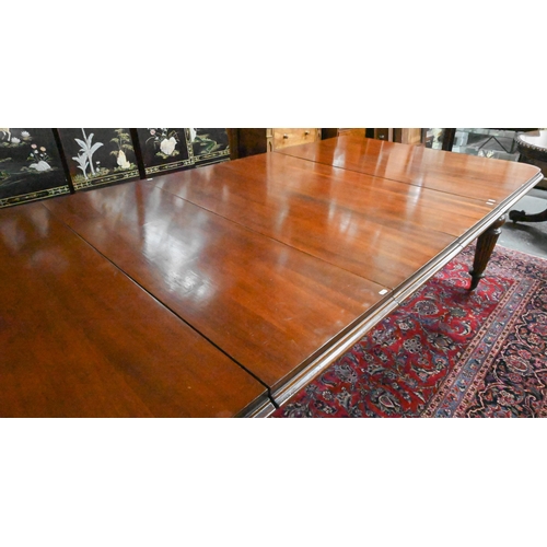 834 - A Victorian mahogany draw leaf extending dining table, raised on turned part gadrooned legs to brass... 