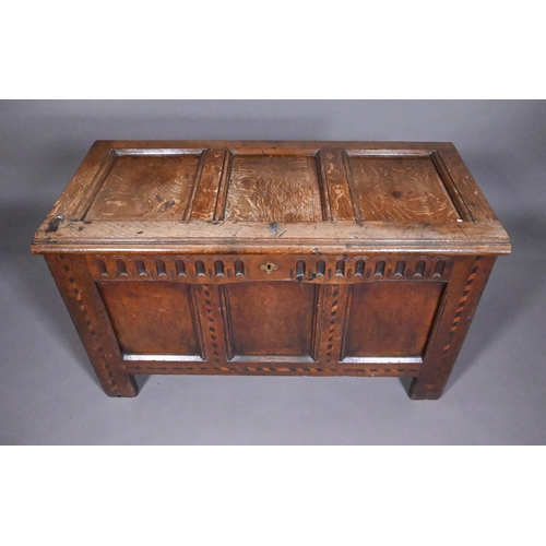 842 - A 17th/18th century chequer inlaid oak coffer, with arcaded frieze over a triple panel front on stil... 