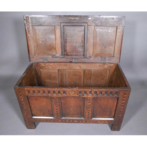 842 - A 17th/18th century chequer inlaid oak coffer, with arcaded frieze over a triple panel front on stil... 