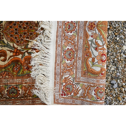 907 - A fine Turkish Hereke silk prayer rug, the profusely floral design on yellow/gold ground, 122 cm x 8... 