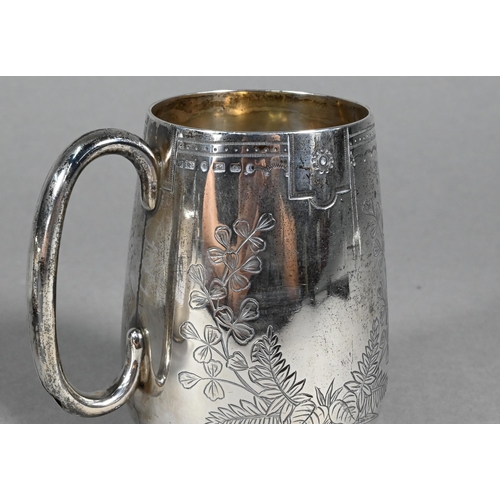 92 - A Victorian foliate-engraved silver Christening mug, London 1885 to/w a porringer, the twin handles ... 