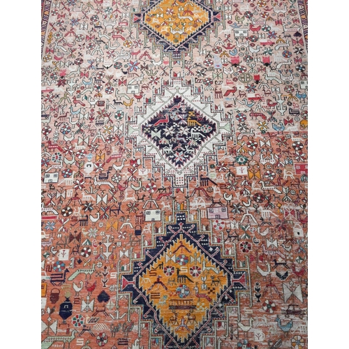 920 - An old Sumak rug, the soft worn pink ground with geometric animals and fauna, 186 x 134 cm