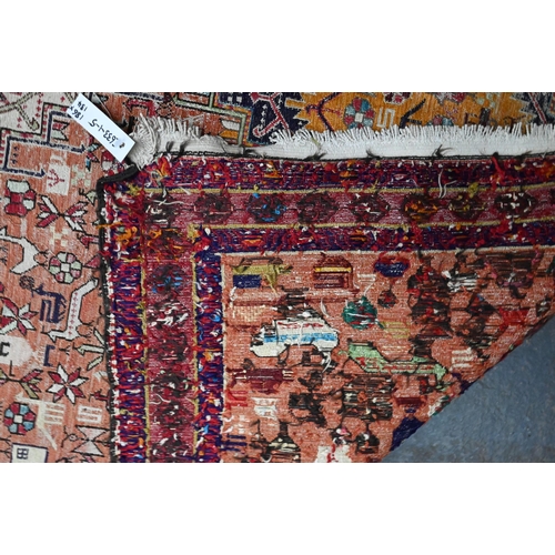920 - An old Sumak rug, the soft worn pink ground with geometric animals and fauna, 186 x 134 cm