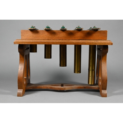 941 - An Edwardian oak-framed xylophone dinner-gong with five brass keys above tubular bells, on lyre supp... 