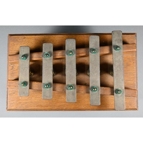 941 - An Edwardian oak-framed xylophone dinner-gong with five brass keys above tubular bells, on lyre supp... 