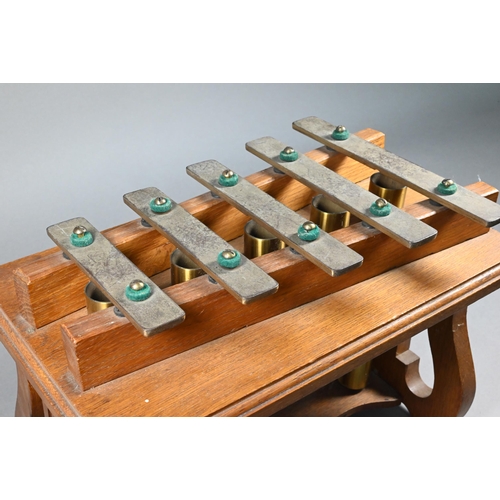 941 - An Edwardian oak-framed xylophone dinner-gong with five brass keys above tubular bells, on lyre supp... 