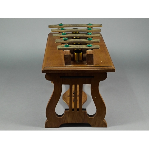941 - An Edwardian oak-framed xylophone dinner-gong with five brass keys above tubular bells, on lyre supp... 