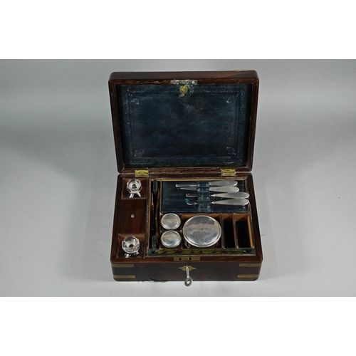 944 - A 19th century brass-bound rosewood toilet case, the fitted interior with bottles, jars and silver-h... 