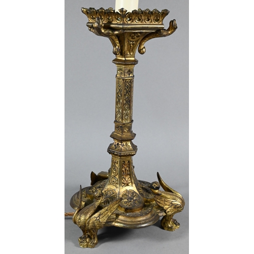 945 - A Victorian Gothic Revival gilt bronze torchère with galleried top supported by mythical beast, on h... 