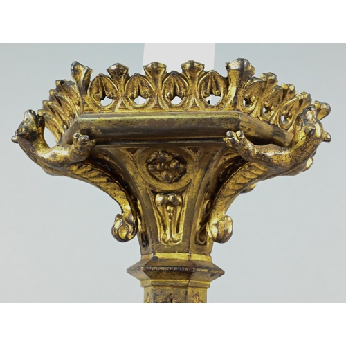 945 - A Victorian Gothic Revival gilt bronze torchère with galleried top supported by mythical beast, on h... 