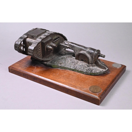 946 - A cast iron novelty mechanical money-box cast with WW1 tank and cannon, on teak base, 10 x 24.5 x 10... 