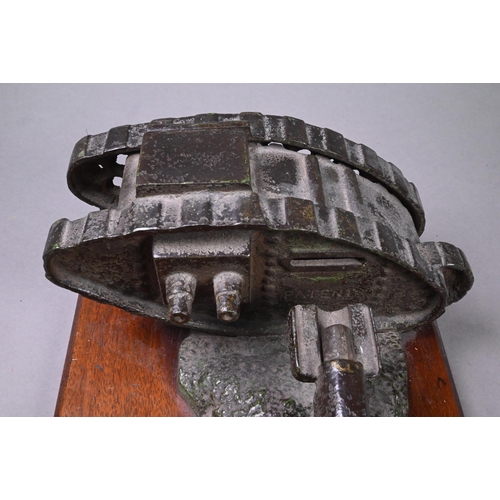 946 - A cast iron novelty mechanical money-box cast with WW1 tank and cannon, on teak base, 10 x 24.5 x 10... 