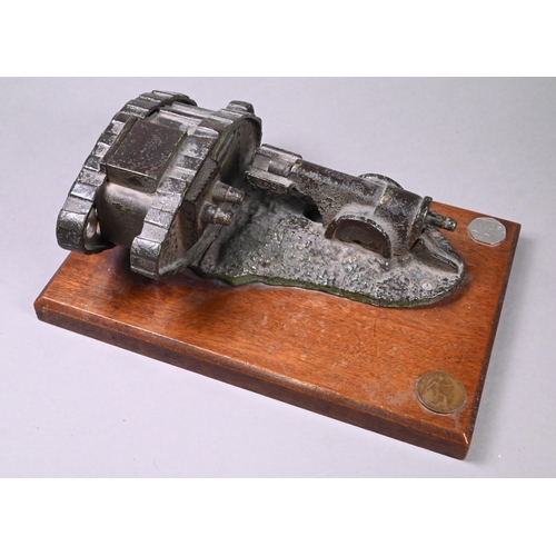 946 - A cast iron novelty mechanical money-box cast with WW1 tank and cannon, on teak base, 10 x 24.5 x 10... 