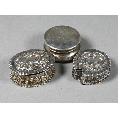 95 - Two embossed silver pill-boxes, Birmingham 1899/1902 to/w an ep plain pill-box (3)