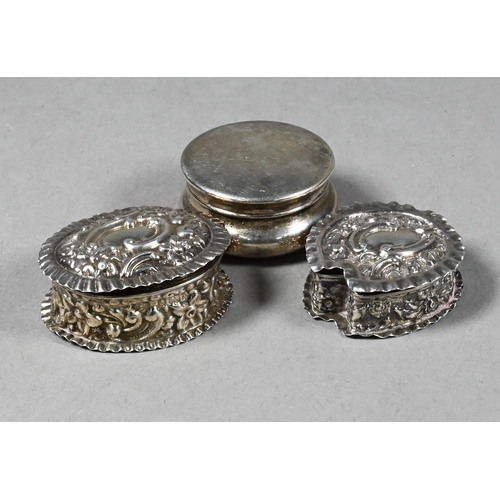 95 - Two embossed silver pill-boxes, Birmingham 1899/1902 to/w an ep plain pill-box (3)