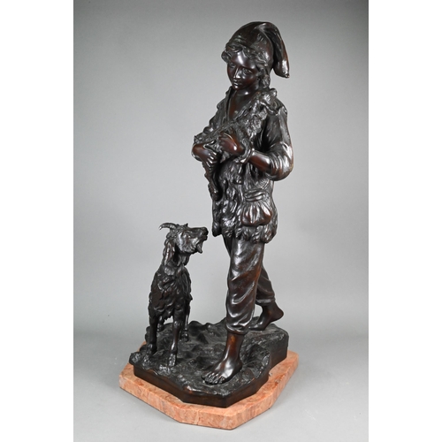 953 - A large dark brown-patinated bronze group, boy goatherd carrying a newborn kid, the mother goat foll... 