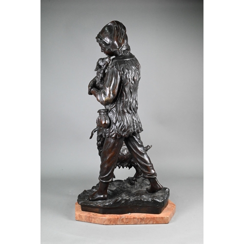 953 - A large dark brown-patinated bronze group, boy goatherd carrying a newborn kid, the mother goat foll... 