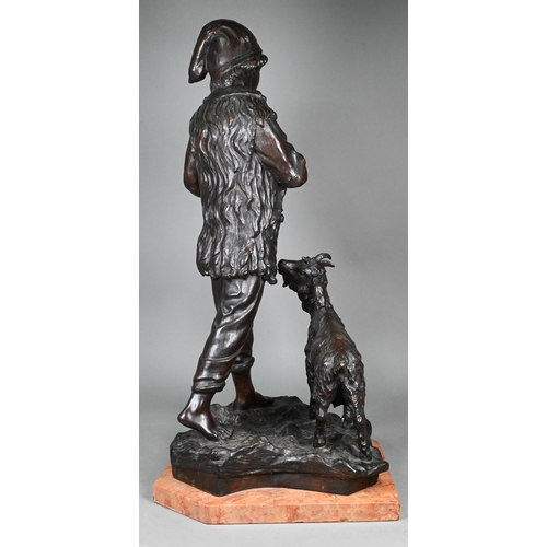 953 - A large dark brown-patinated bronze group, boy goatherd carrying a newborn kid, the mother goat foll... 