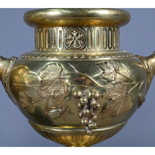 957 - Pair of 19th century French brass garniture urns with relief vine and insects decoration, 30 cm high