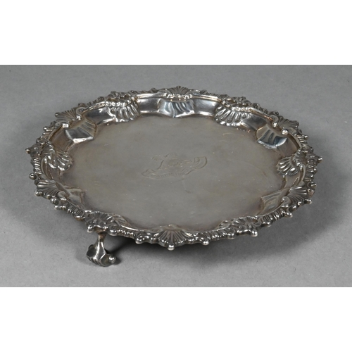 96 - A late Victorian silver card salver in the Georgian manner, with shell and gadroon-moulded rim, on t... 