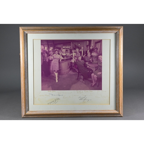 963 - A 1960s photograph of the cast of Coronation Street, taken in The Rovers Return, the mount signed by... 