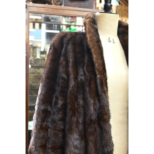 970 - A vintage leopard-skin stole with black satin lining, to/w a calf-length mink coat with fitted cuffs... 