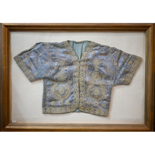 973 - A vintage Northern Indian embroidered jacket with gold and silver thread on a blue ground, in glazed... 