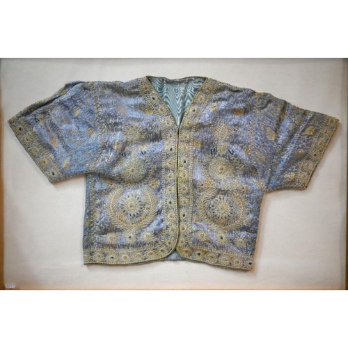 973 - A vintage Northern Indian embroidered jacket with gold and silver thread on a blue ground, in glazed... 